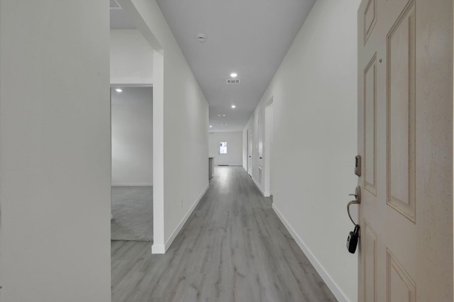 Welcoming entry with extended hallway, fresh interior paint, and updated flooring that flows into the main living areas. Welcoming entry with extended hallway, fresh interior paint, and updated flooring that flows into the main living areas.