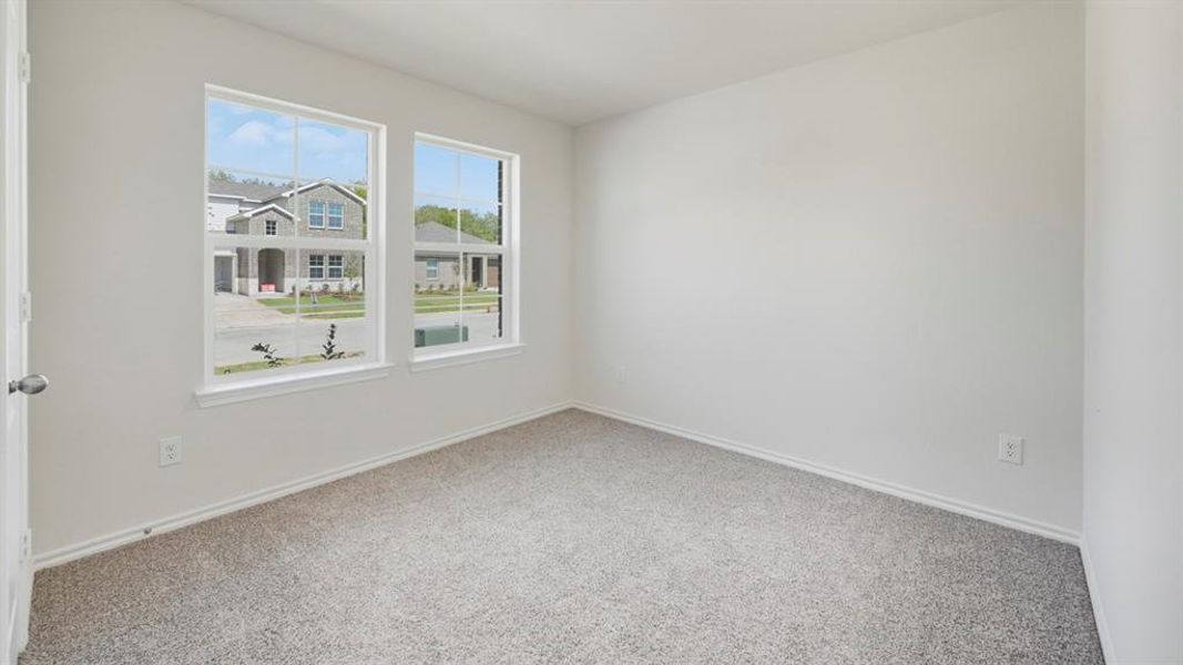 Empty room with carpet floors and baseboards Empty room with carpet floors and baseboards