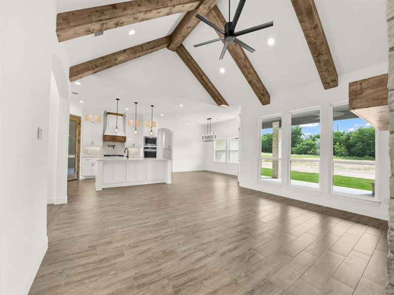 Kitchen with a sink, a ceiling fan, a center island with sink, recessed lighting, and a fireplace Kitchen with a sink, a ceiling fan, a center island with sink, recessed lighting, and a fireplace