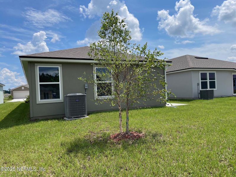 Front exterior of a new home in The Arbors, Jacksonville, FL, highlighting curb appeal (Image 26). Front exterior of a new home in The Arbors, Jacksonville, FL, highlighting curb appeal (Image 26).