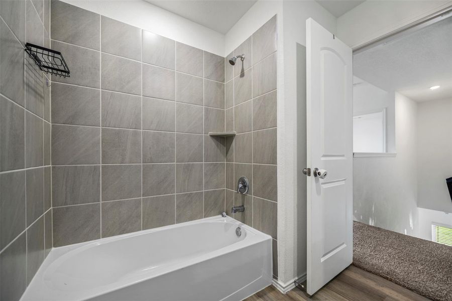 Upstairs bath with a tiled tub/shower combo Upstairs bath with a tiled tub/shower combo