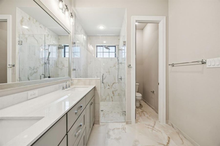 Large walk-in shower and double sinks in vanity. Large walk-in shower and double sinks in vanity.