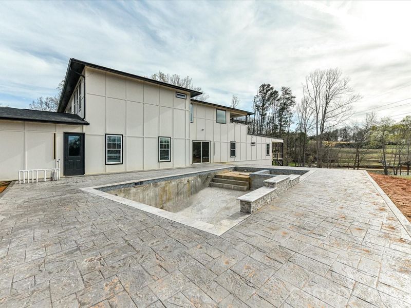 Spacious outdoor patio with an in-ground pool and spa, offering a great opportunity to customize your dream backyard retreat.