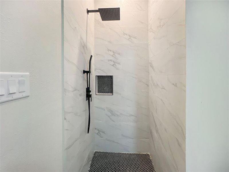 Bathroom featuring a marble finish shower Bathroom featuring a marble finish shower