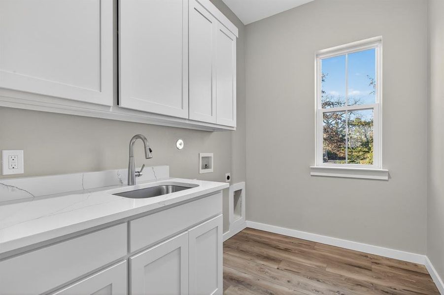 Gorgeous laundry area with sink, great views and plenty of cabinet space.
