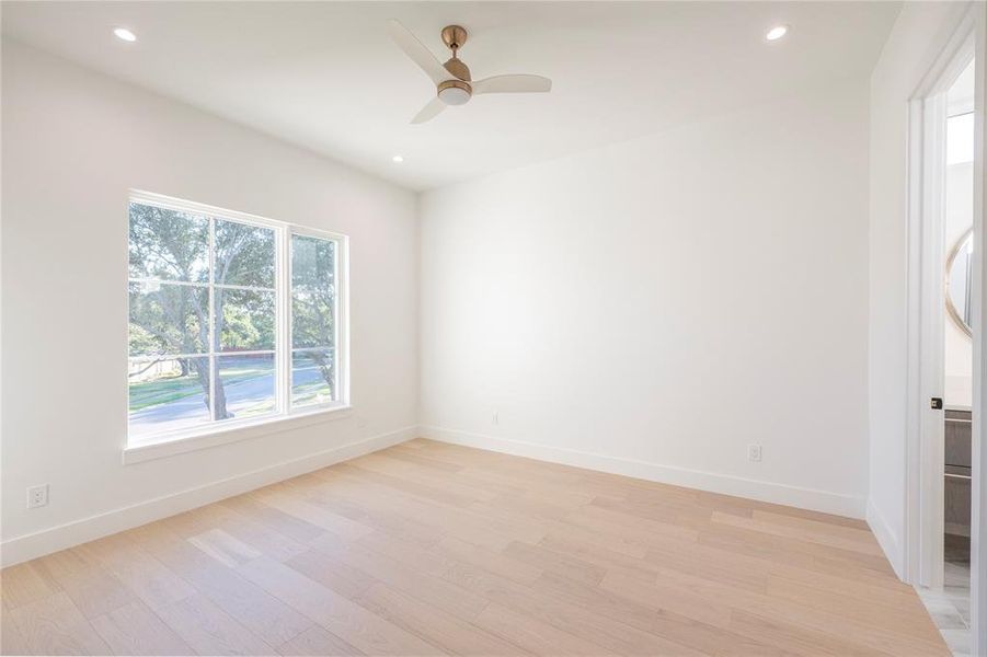 Unfurnished room with light hardwood / wood-style flooring and ceiling fan