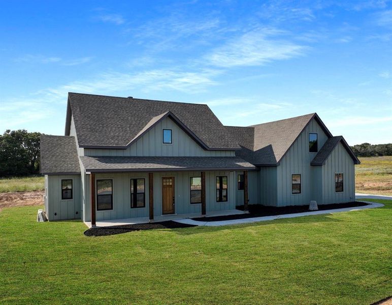 Modern farmhouse featuring a porch and a front lawn