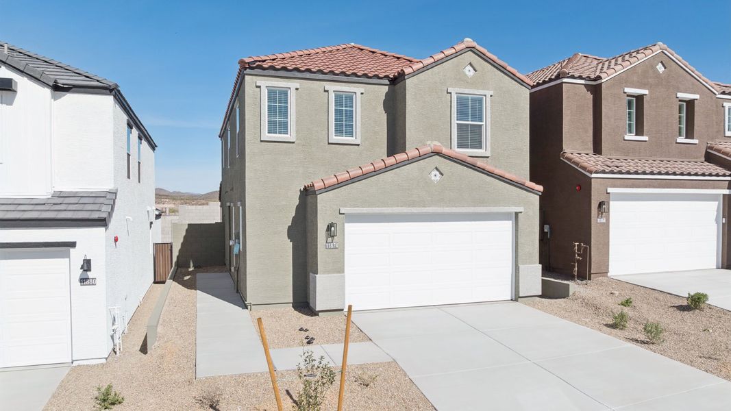 Front exterior of a new home in The Buttes at Mystic, Peoria, AZ, highlighting curb appeal (Image 2).