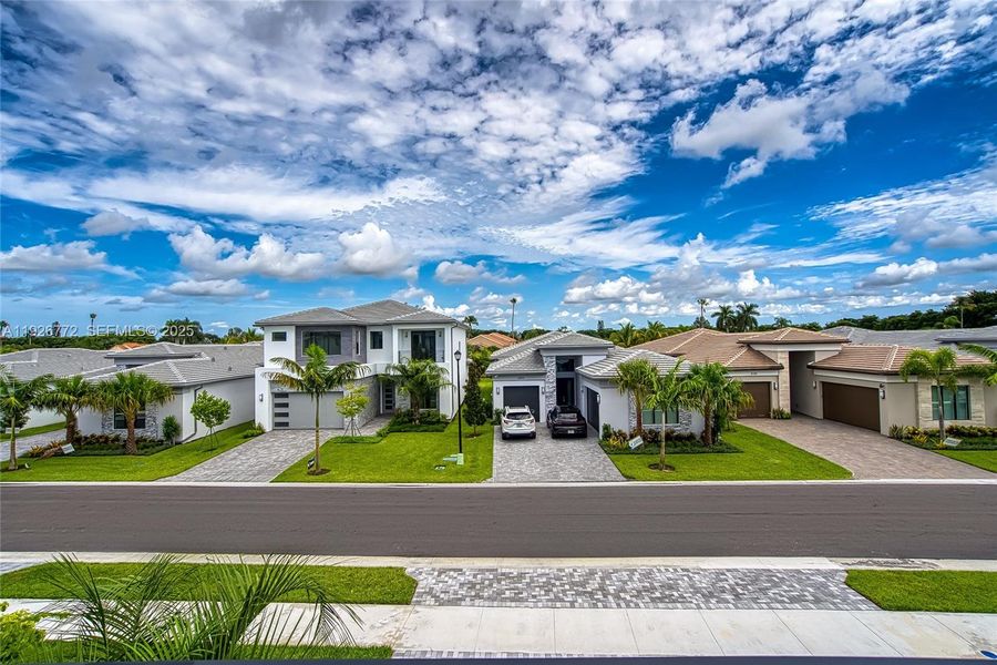 Front exterior of a new home in Lotus Edge, Boca Raton, FL, highlighting curb appeal (Image 27). Front exterior of a new home in Lotus Edge, Boca Raton, FL, highlighting curb appeal (Image 27).
