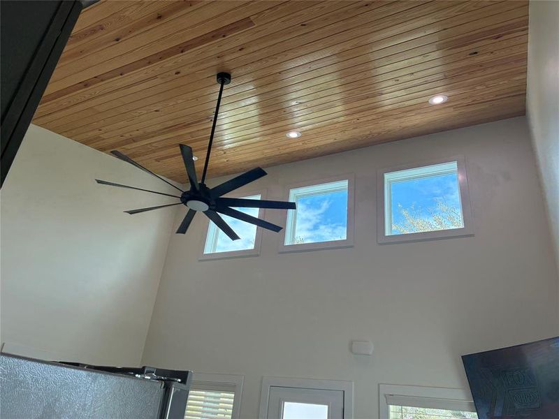 Detailed view of wooden ceiling, ceiling fan, and recessed lighting