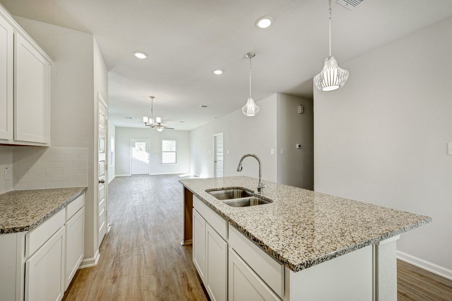 Kitchen into Family Room. Sample image for illustration; upgrades, options, and colors may vary. Kitchen into Family Room. Sample image for illustration; upgrades, options, and colors may vary.