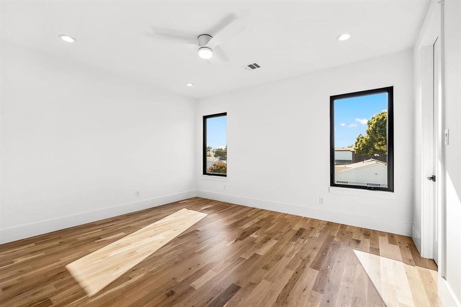 Unfurnished room with plenty of natural light, light wood-style flooring, recessed lighting, and ceiling fan Unfurnished room with plenty of natural light, light wood-style flooring, recessed lighting, and ceiling fan