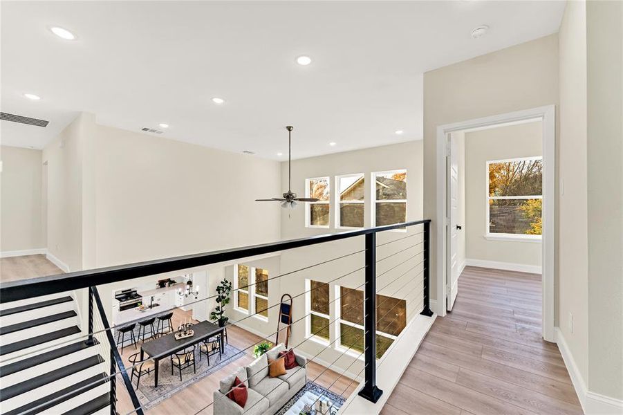 Hallway featuring a wealth of natural light and light hardwood / wood-style flooring