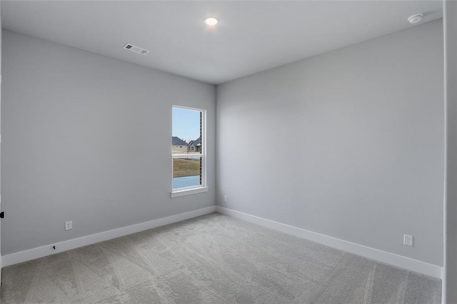 Empty room featuring light colored carpet and recessed lighting