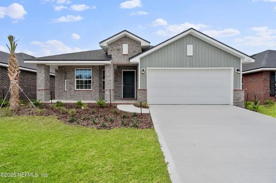 Front exterior of a new home in Palm Coast, Palm Coast, FL, highlighting curb appeal (Image 1). Front exterior of a new home in Palm Coast, Palm Coast, FL, highlighting curb appeal (Image 1).