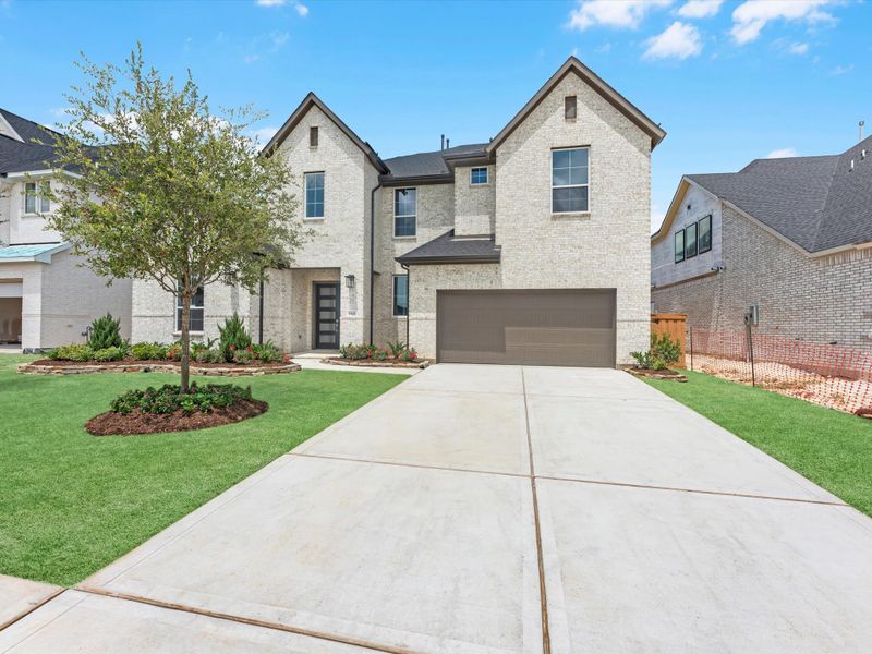 Front exterior of a new home in Dunham Pointe, Cypress, TX, highlighting curb appeal (Image 2). Front exterior of a new home in Dunham Pointe, Cypress, TX, highlighting curb appeal (Image 2).