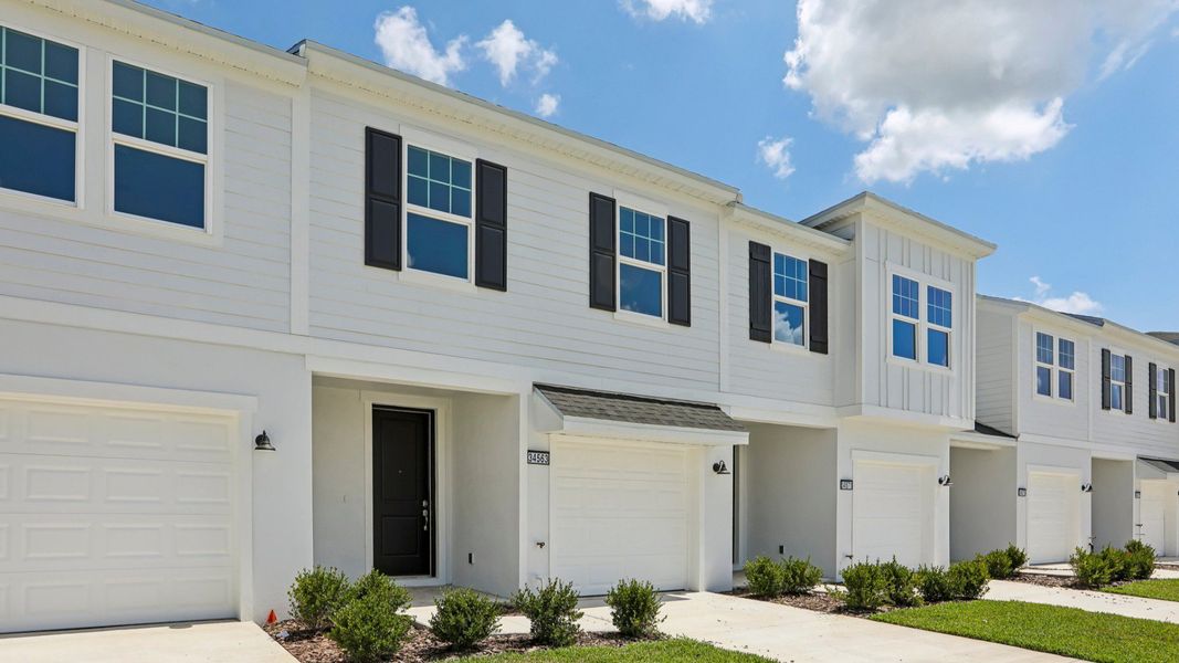 Front exterior of a new home in Twin Oaks, Zephyrhills, FL, highlighting curb appeal (Image 23).