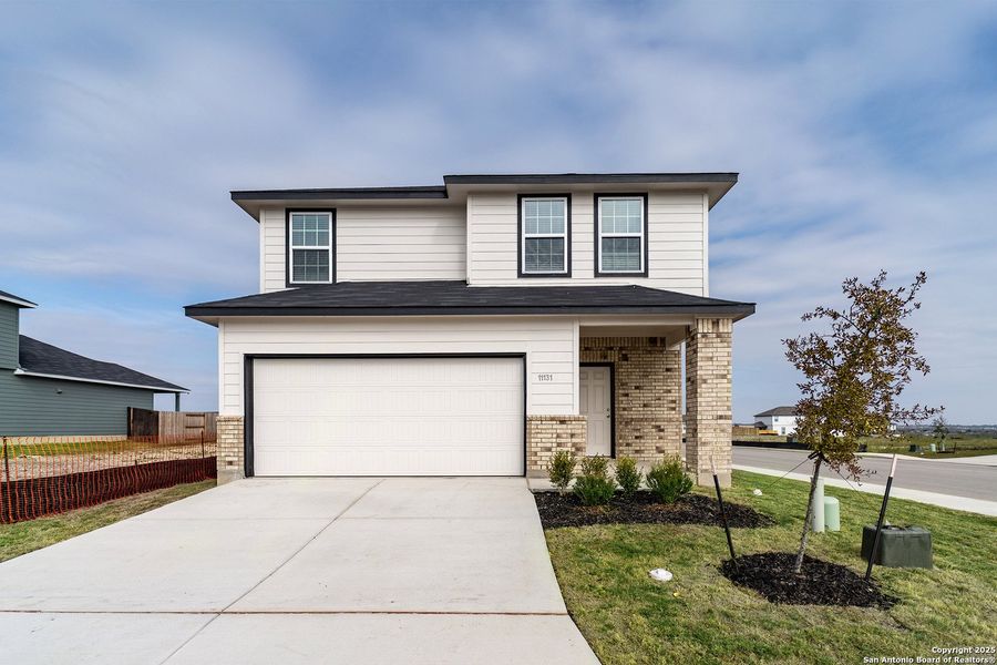 Front exterior of a new home in Katzer Ranch, Converse, TX, highlighting curb appeal (Image 1). Front exterior of a new home in Katzer Ranch, Converse, TX, highlighting curb appeal (Image 1).