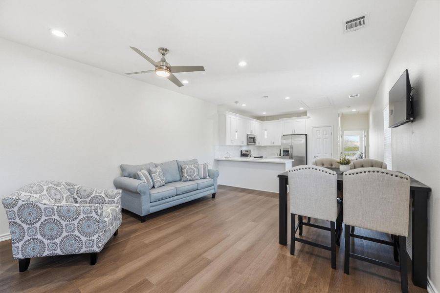 This open living space offers flexibility for relaxing or entertaining, with abundant natural light and a seamless layout designed for both everyday living and short-term rental use.