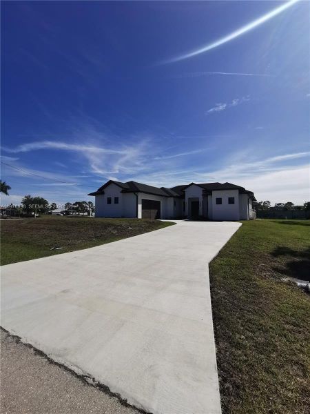 Front exterior of a new home in , Cape Coral, FL, highlighting curb appeal (Image 20).