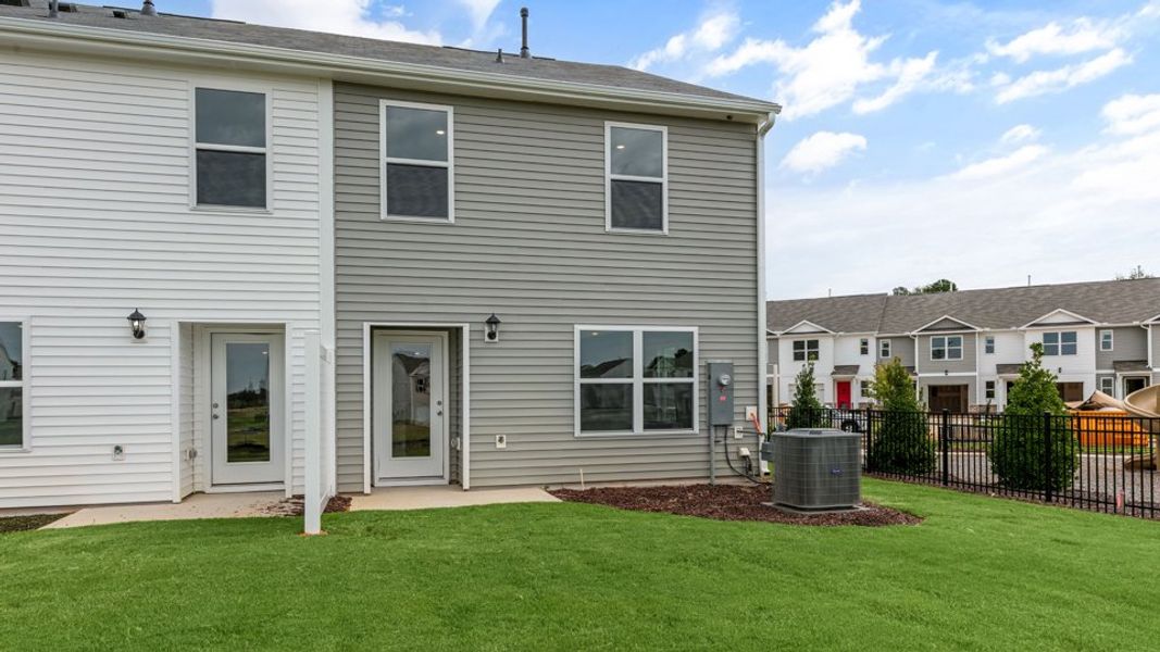 Exterior details and patio area of a home in The Townes at Hunter Hill, Rocky Mount (Image 23).