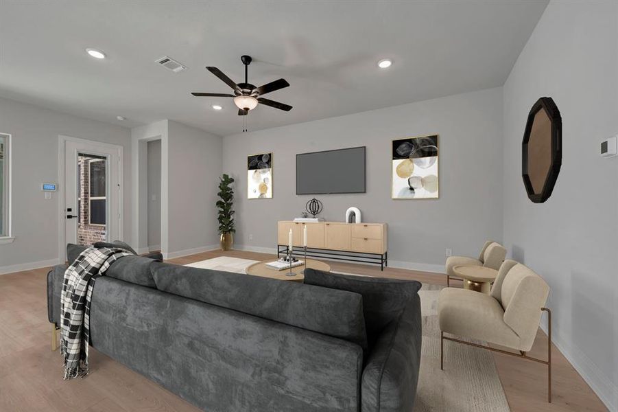Living room with light wood-style floors, recessed lighting, and a ceiling fan