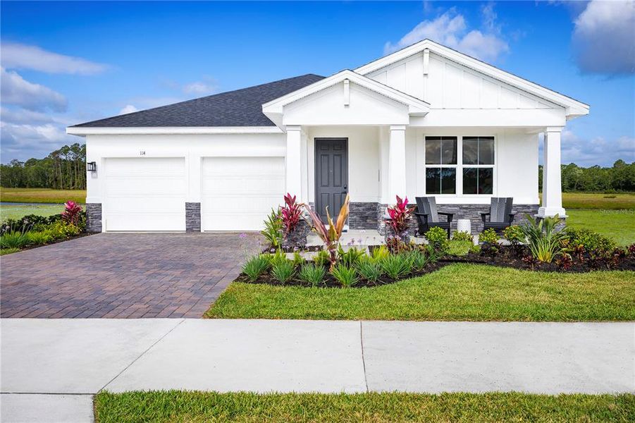 Front exterior of a new home in The Palms at Venetian Bay, New Smyrna Beach, FL, highlighting curb appeal (Image 1). Front exterior of a new home in The Palms at Venetian Bay, New Smyrna Beach, FL, highlighting curb appeal (Image 1).