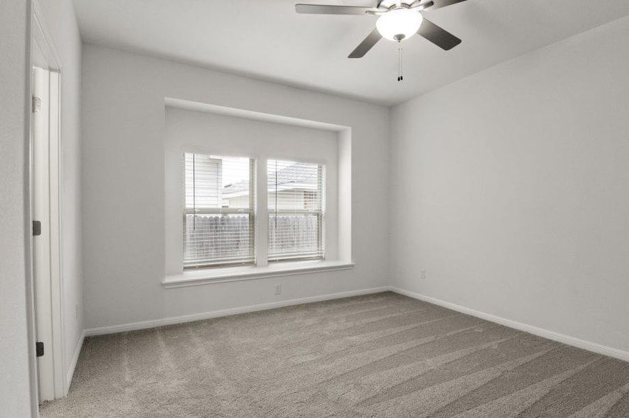 Unfurnished room featuring a ceiling fan and light colored carpet Unfurnished room featuring a ceiling fan and light colored carpet