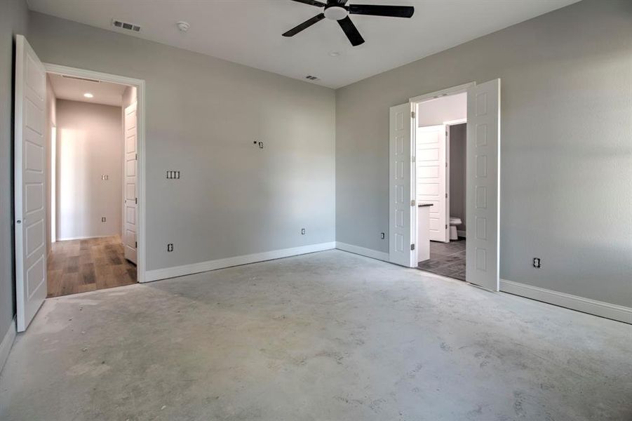 Unfurnished bedroom with ceiling fan and concrete floors