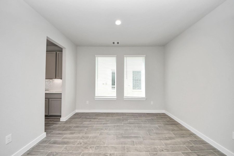 Create lasting memories with your family and friends at the dining table! This expansive dining room showcases sophisticated flooring, custom paint, and seamlessly connects to the family room and kitchen, providing an open and inviting atmosphere. Sample photo of completed home with similar floor plan. Actual colors and selections may vary. Create lasting memories with your family and friends at the dining table! This expansive dining room showcases sophisticated flooring, custom paint, and seamlessly connects to the family room and kitchen, providing an open and inviting atmosphere. Sample photo of completed home with similar floor plan. Actual colors and selections may vary.