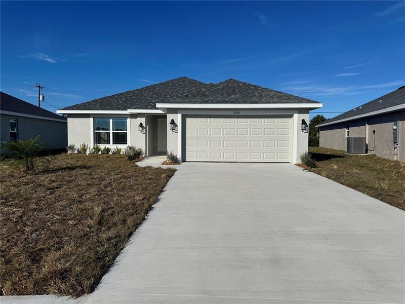 Front exterior of a new home in Watercress Cove, North Port, FL, highlighting curb appeal (Image 1). Front exterior of a new home in Watercress Cove, North Port, FL, highlighting curb appeal (Image 1).