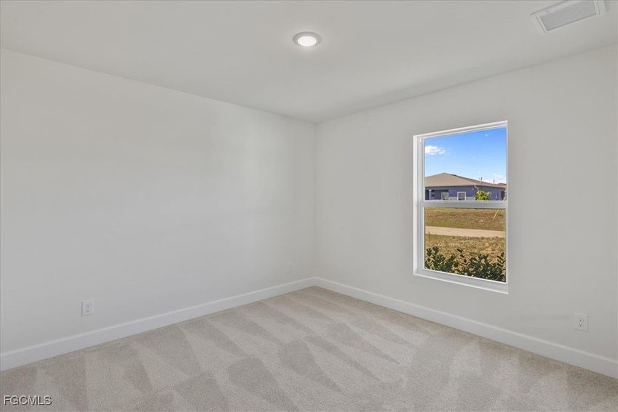 Carpeted empty room featuring baseboards