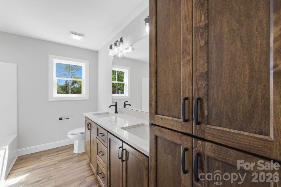 Secondary Bathroom w/ custom cabinetry and extra storage