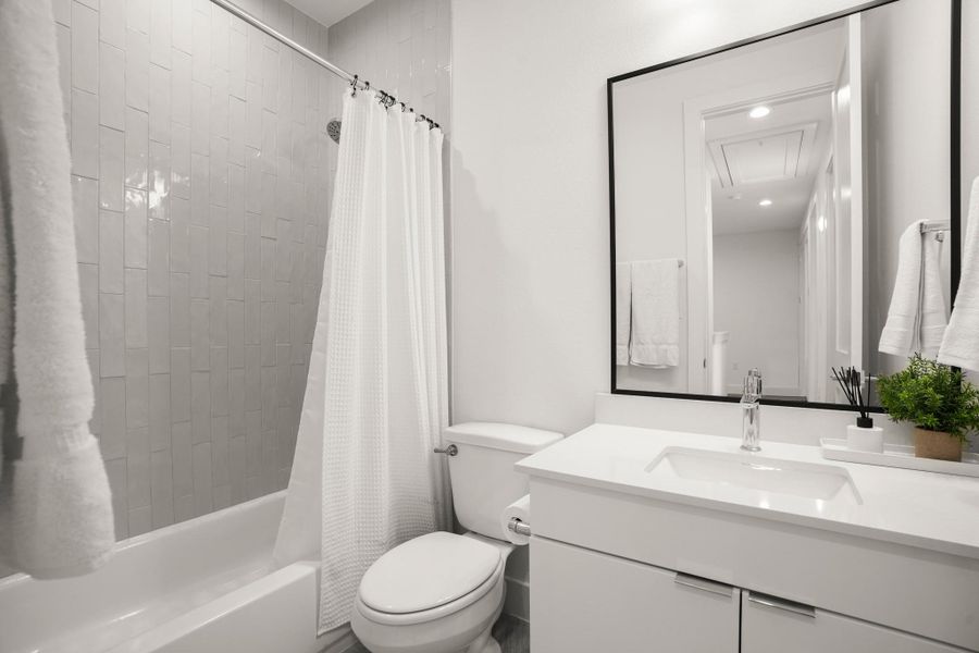 The full guest bathroom upstairs is shared by the secondary bedrooms and also comes with sleek contemporary finishes. The full guest bathroom upstairs is shared by the secondary bedrooms and also comes with sleek contemporary finishes.