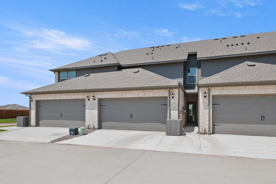 Front exterior of a new home in Sanger Circle – Townhomes, Sanger, TX, highlighting curb appeal (Image 28). Front exterior of a new home in Sanger Circle – Townhomes, Sanger, TX, highlighting curb appeal (Image 28).