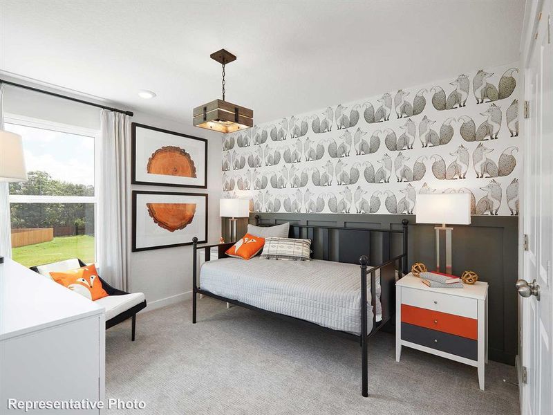 The room features a window with white curtains, patterned wallpaper, and light-colored carpeting