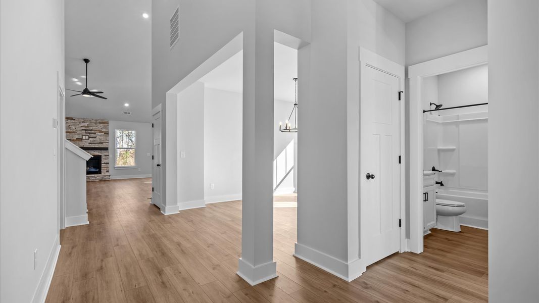 Memorable arrival experience with hardwood floors and elegant trim in the foyer