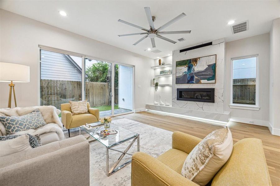 The airy living room features a seamless flow to the outdoor area through sliding glass doors, creating an inviting space.