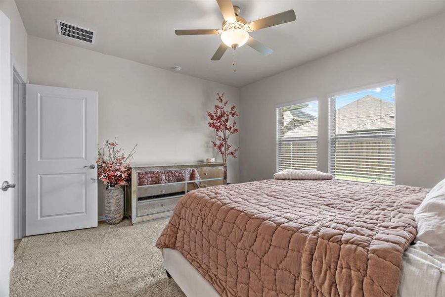 Carpeted bedroom featuring ceiling fan Carpeted bedroom featuring ceiling fan