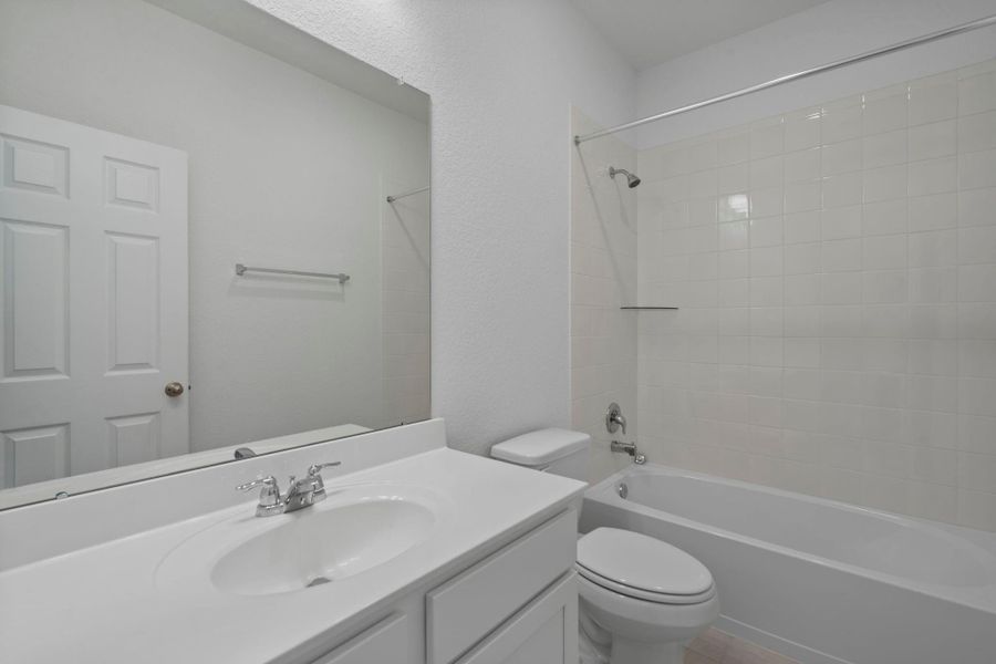 The secondary bath features tile flooring, white cabinetry and light countertops and a shower/tub combo. Perfect for accommodating any visiting family and friends. The secondary bath features tile flooring, white cabinetry and light countertops and a shower/tub combo. Perfect for accommodating any visiting family and friends.