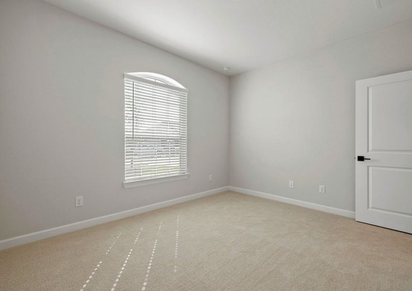 Spacious bedroom with carpet floooring