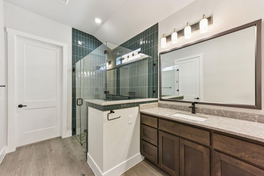 Bathroom with vanity, light wood-style floors, and a shower stall Bathroom with vanity, light wood-style floors, and a shower stall