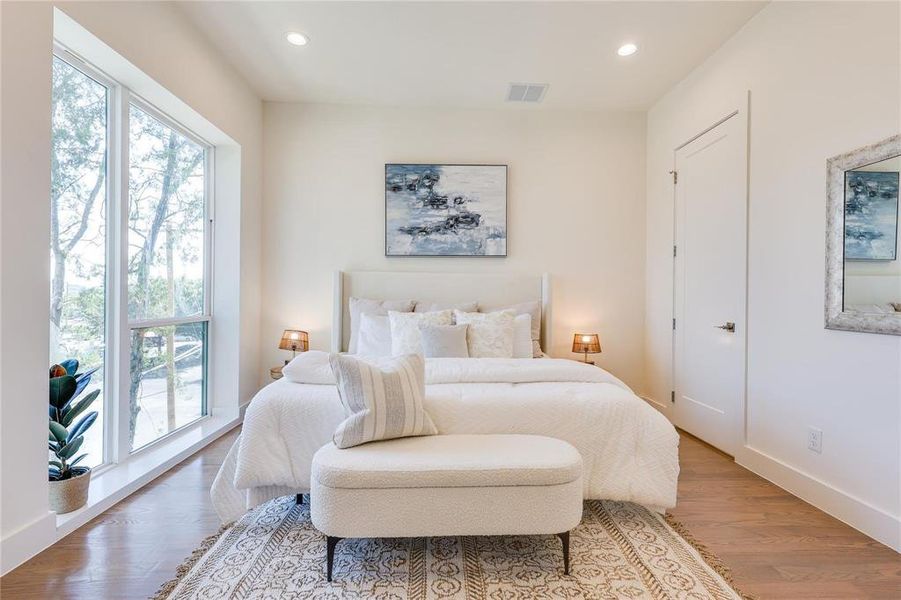 Bedroom with hardwood / wood-style flooring