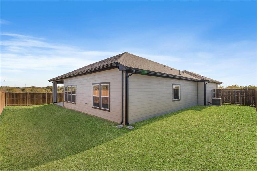 View of property exterior featuring cooling unit and a lawn View of property exterior featuring cooling unit and a lawn