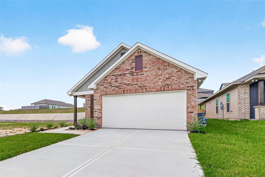 Front exterior of a new home in Mostyn Springs, Magnolia, TX, highlighting curb appeal (Image 21). Front exterior of a new home in Mostyn Springs, Magnolia, TX, highlighting curb appeal (Image 21).