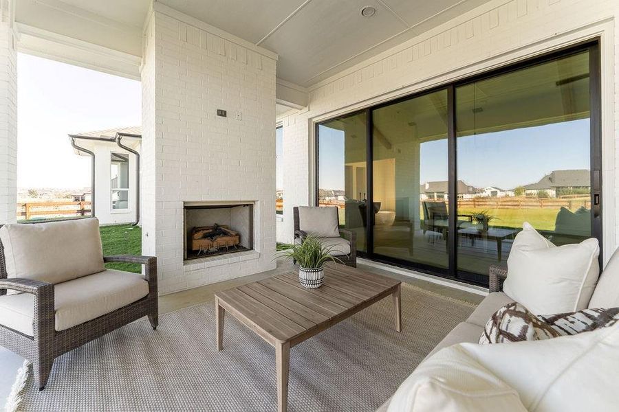 View of patio with an outdoor living space with a fireplace