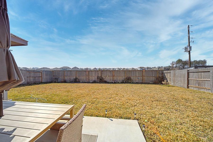 Exterior details and patio area of a home in Pinewood at Grand Texas, New Caney (Image 3).