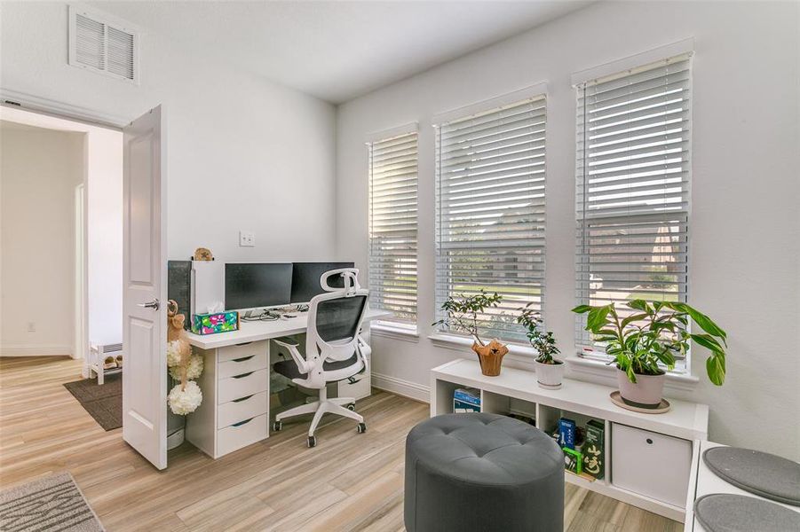 Office area featuring light wood-style flooring