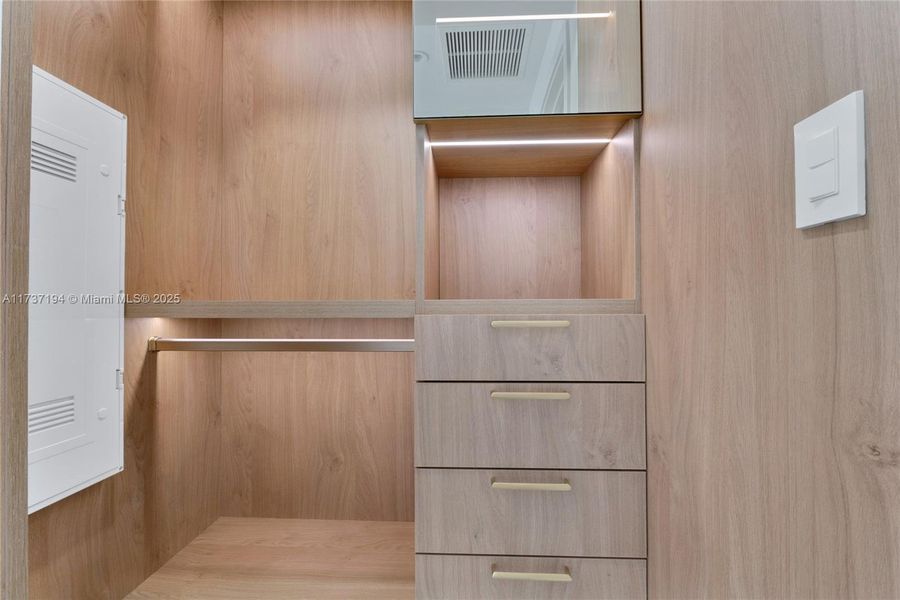 The second bedroom features a custom Italkraft walk-in closet with LED lighting and thoughtfully designed storage.