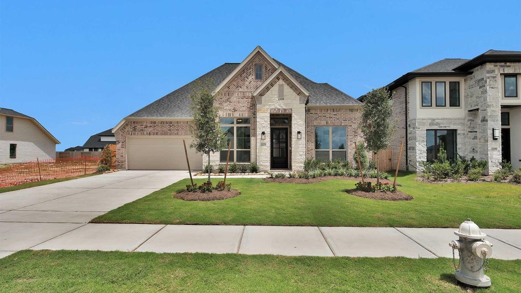 Front exterior of a new home in StoneCreek Estates, Richmond, TX, highlighting curb appeal (Image 2). Front exterior of a new home in StoneCreek Estates, Richmond, TX, highlighting curb appeal (Image 2).